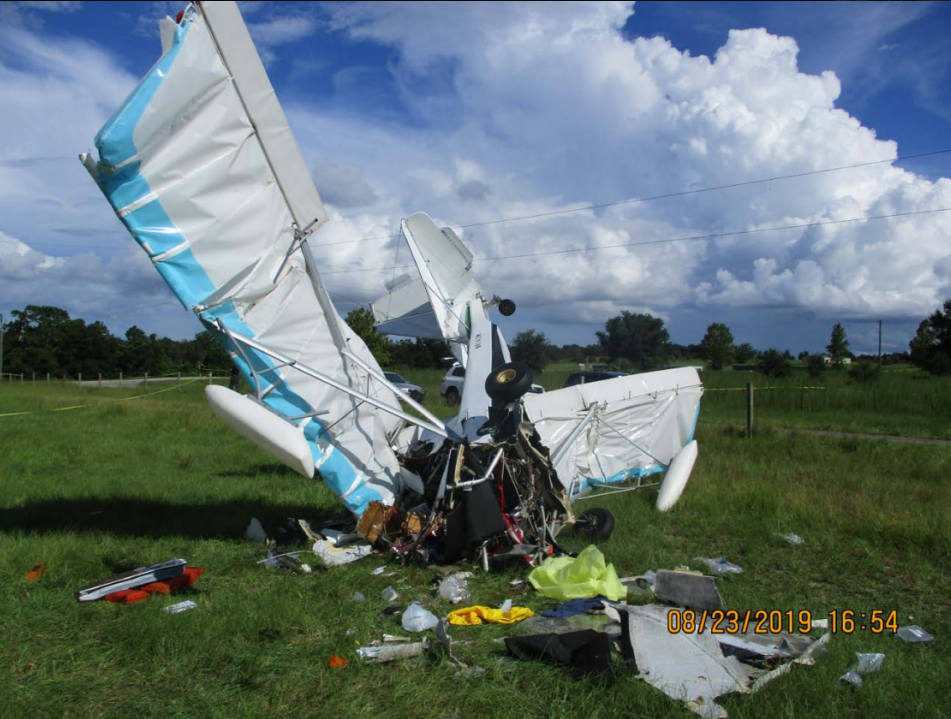 The wreckage of an experimental aircraft, N9143M, is seen in a field.