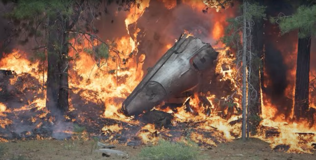 The burning wreckage of an airplane, registration N605TR.