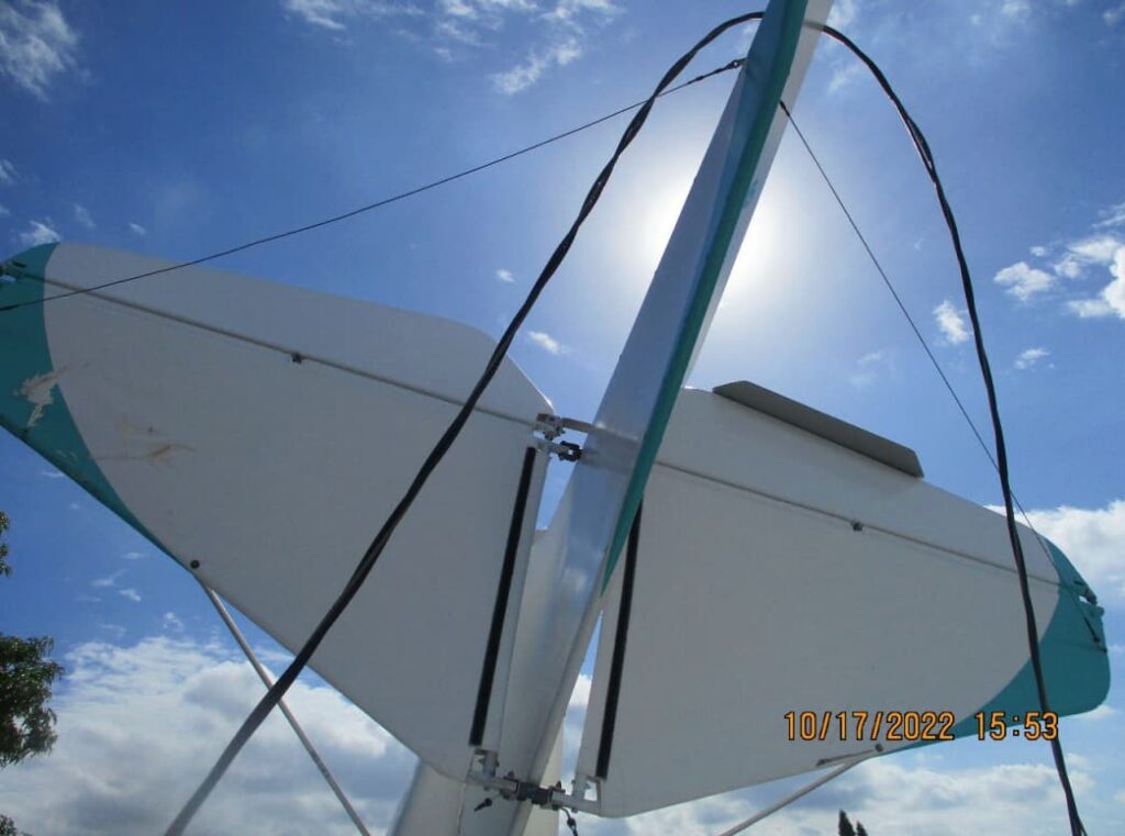 Horizontal stabilizer and elevator surfaces of the airplane seen from below, showing control linkages and cables intact after the accident.