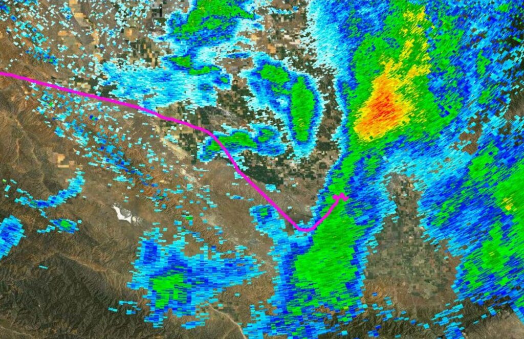 Flight track of the accident aircraft overlaid on weather radar. The pink line shows the Piper's route heading southeast toward Las Vegas as it flew directly into an area of heavy precipitation. The track ends abruptly where the aircraft broke apart in flight.
