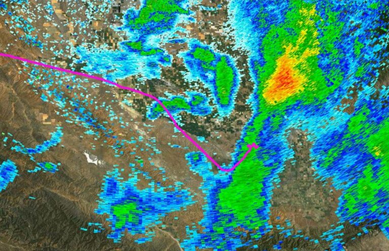 Flight track of the accident aircraft overlaid on weather radar. The pink line shows the Piper's route heading southeast toward Las Vegas as it flew directly into an area of heavy precipitation. The track ends abruptly where the aircraft broke apart in flight.