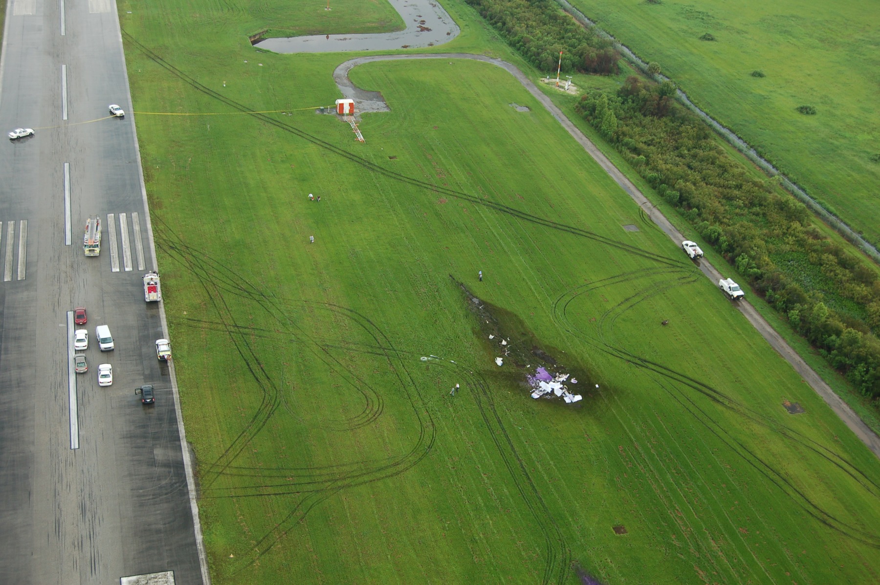 MIA08FA144 — Photo 2 - Aerial photo of crash site looking back to ILS antenna. Photo Hillsborough Sheriffs Dept, page 1 (NTSB docket)